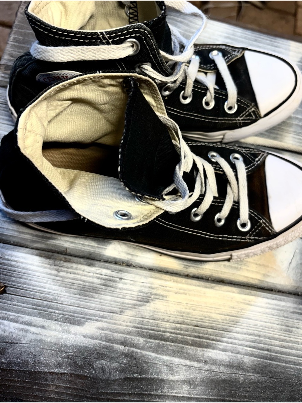 Black Converse sneakers with white rubber toe cap and womens 6.5